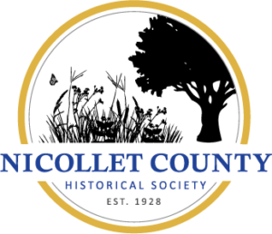 A circular logo for the Nicollet County Historical Society, celebrating the past cultivating the future, features black silhouettes of grass, a butterfly, and a tree, with the organization's name and "Est. 1928" below in blue and gold.