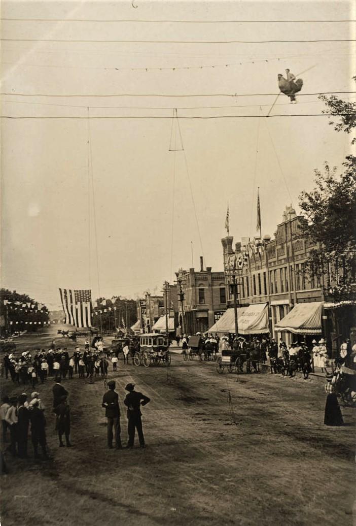 "The Great Dubell" walking on a tightrope that was strung across South Minnesota Avenue at the Nassau Street intersection during the Fourth of July celebration in 1908. 