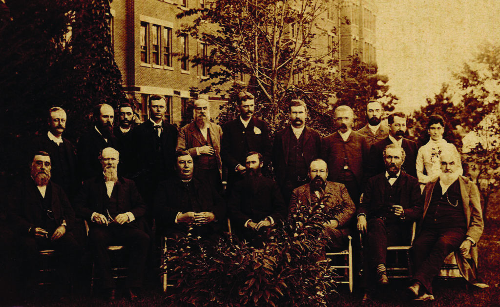 State Hospital Officers and Trustees. They include the following: Rev. Aaron H. Kerr (front right) and William Schimmel (front left), both from St. Peter. Others whose names are listed on the back of the photo include: G. W. Dryer (George W. Dryer), Dr. Bartlett (Cyrus K. Bartlett), and Major Sackett (Addison L. Sackett), all of St. Peter). Other names are listed, but are not easily read. It is not certain where the photo was taken.