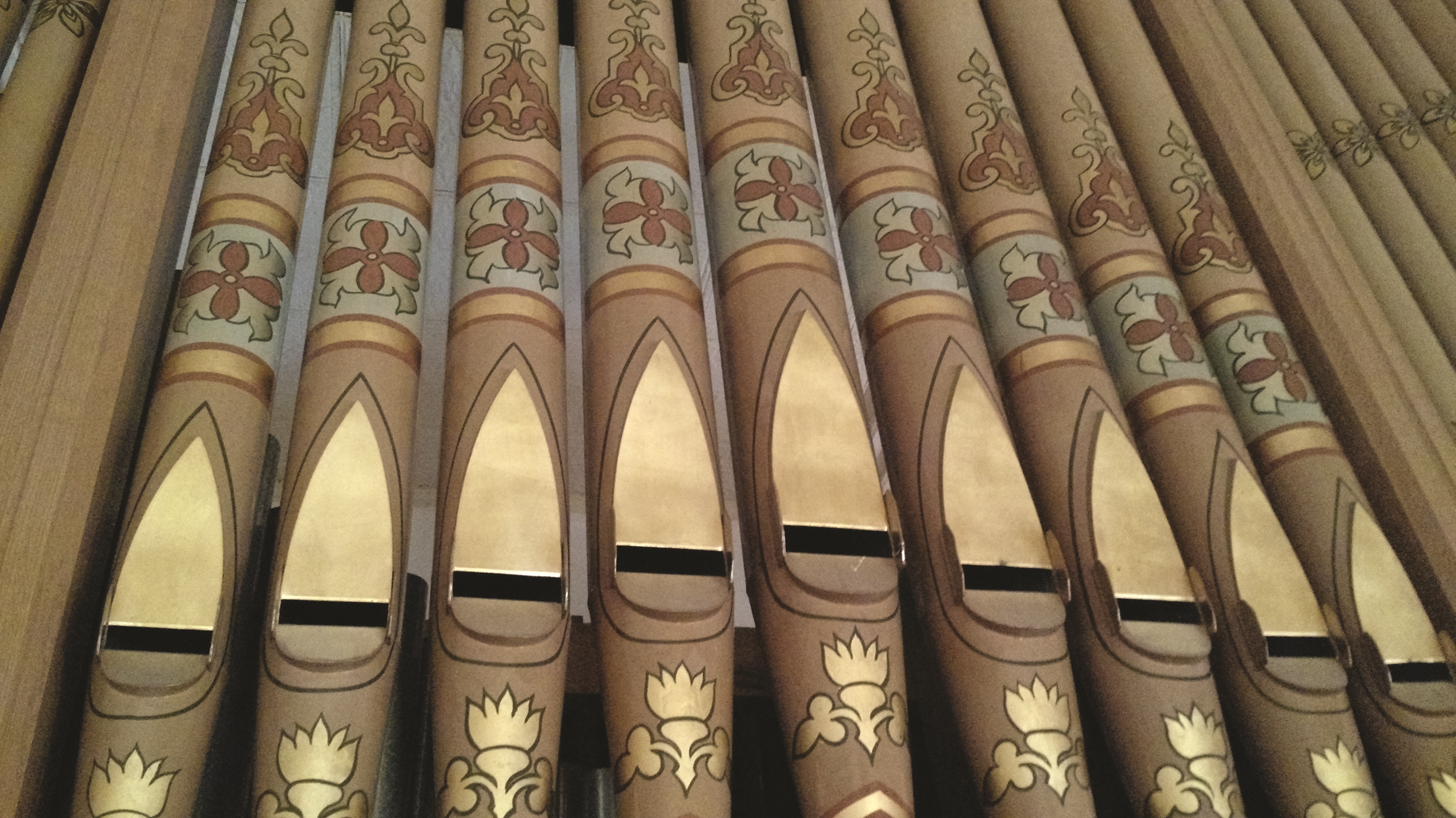 a row of organ pipes with designs on them