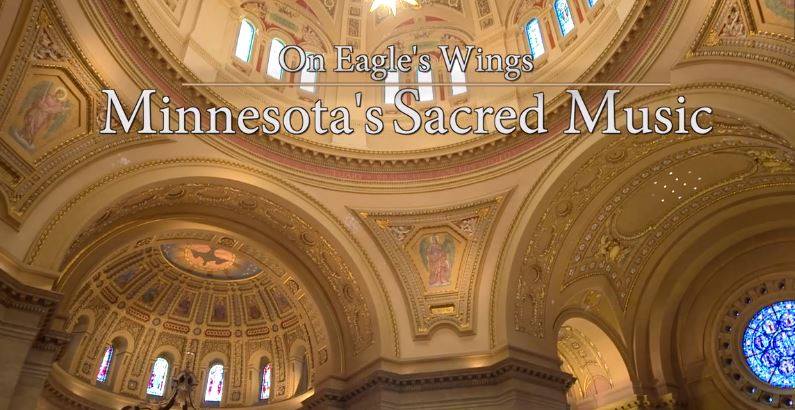 The image shows a richly decorated cathedral ceiling with ornate designs and stained glass windows. Text overlay reads "On Eagle's Wings: Minnesota's Sacred Music.
