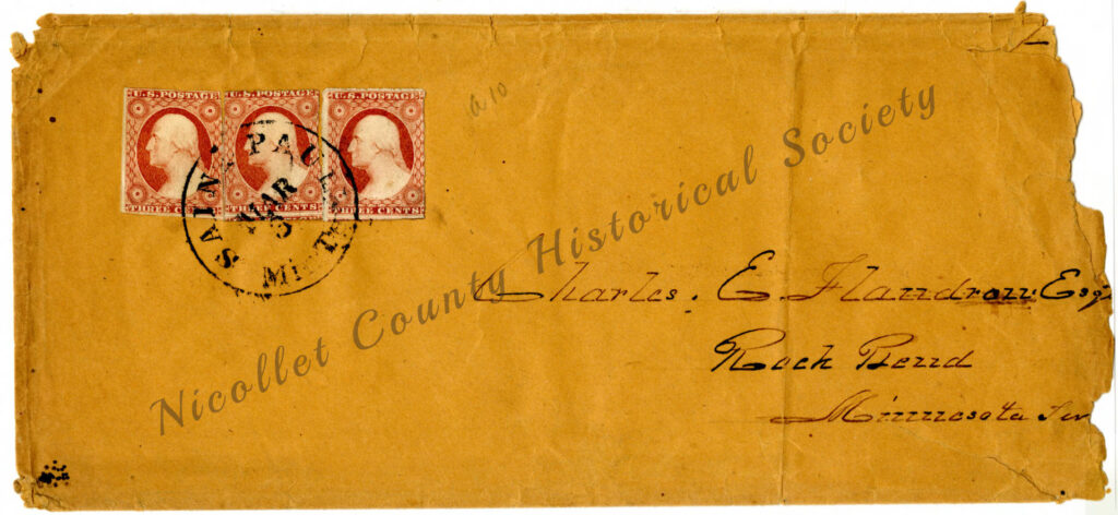A vintage brown envelope with two red three-cent U.S. stamps and a black circular postal mark. The envelope is addressed to Charles E. Flandrau, Roch Peind, Minnesota, with “Nicollet County Historical Society” printed diagonally.