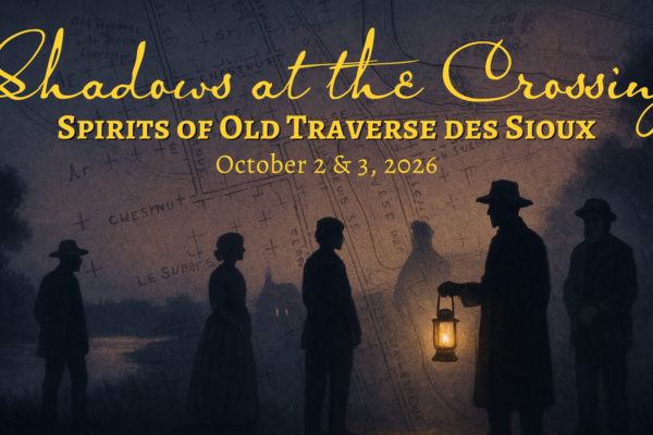 Silhouetted figures in old-fashioned hats and coats stand in front of a map background. One person holds a lantern, their face awash in ghostly light. Text reads: “Shadows at the Crossing: Spirits of Old Traverse des Sioux, October 2 & 3, 2026.”.